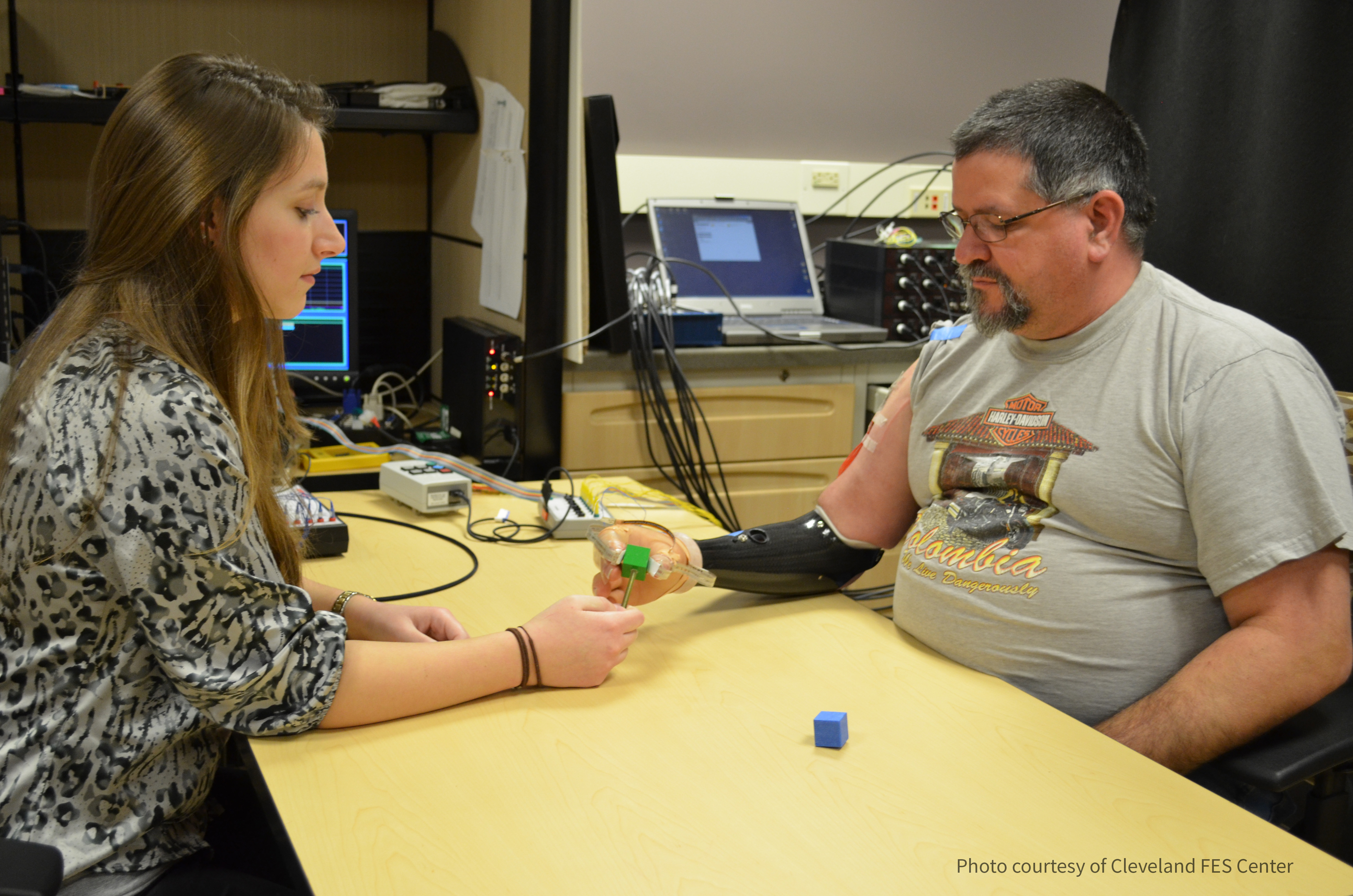 Dr. Graczyk testing the prosthetic arm of a research subject